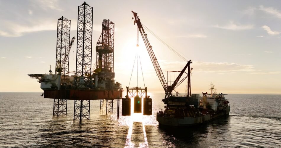 An oil rig being serviced by a supply ship.
