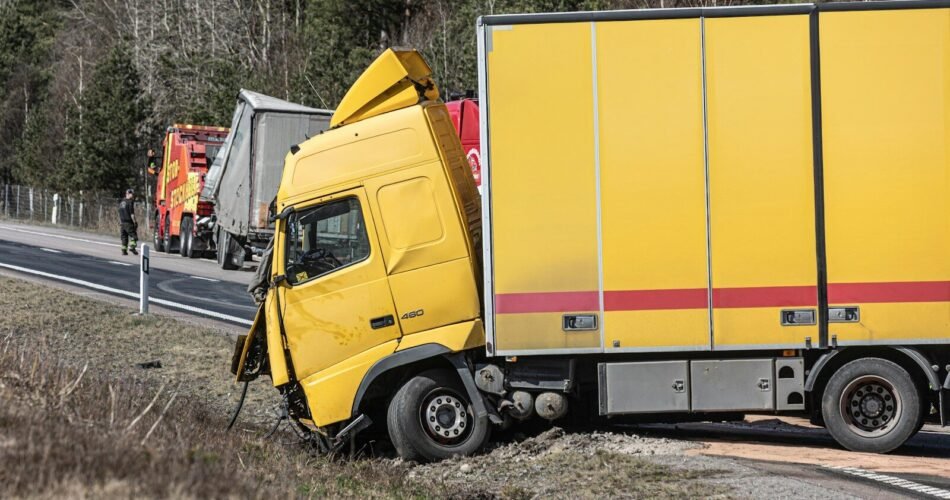 A yellow semi-truck is in a roadside accident.