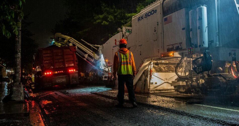 man wearing orange hard hat standing near truck