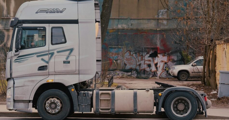 A white semi-truck parked on a street.