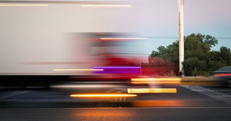 a blurry photo of a truck driving down the road